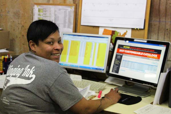 Employee at computer smiling