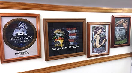 Wall of framed custom shirt art