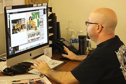 Artist at computer designing