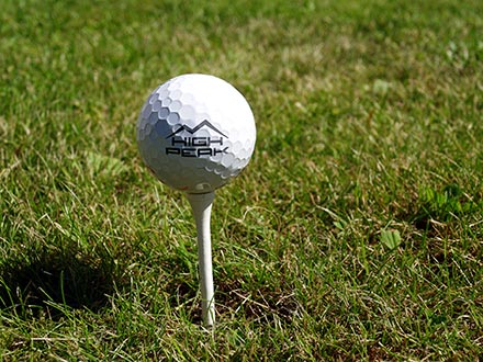 Golf ball on tee with logo