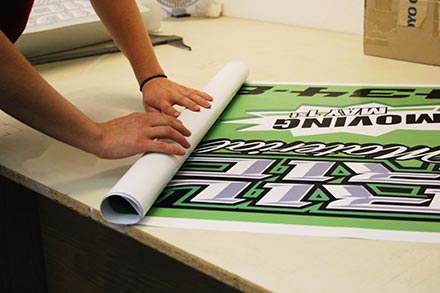 Printed banner being rolled up