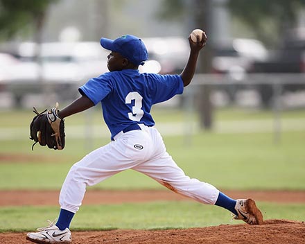 Young baseball player pitching